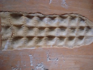 Cover meat filling with a second pasta sheet. With a "Crimper" seal and cut pasta squares.